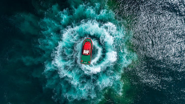 Top View Photo Of Boat On Ocean