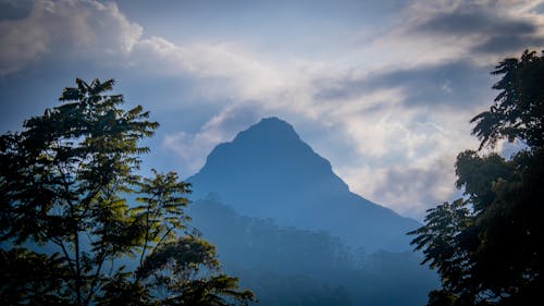 Silhouette of Mountain Among Clouds