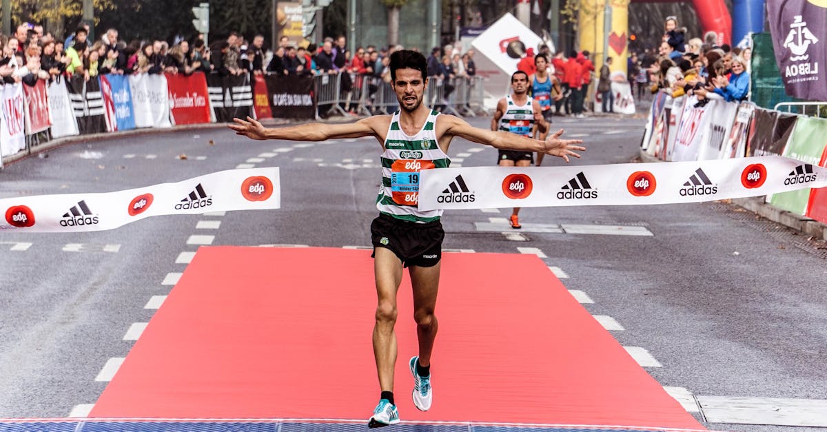 A triumphant marathon winner crosses the finish line, embodying athletic success.