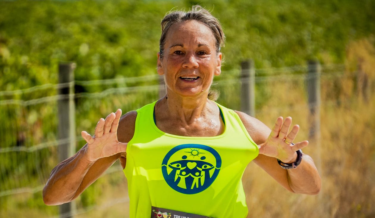 Woman Stretching Out Her Green Tank Top