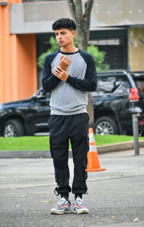 Handsome Young Man in Sweatshirt on Street