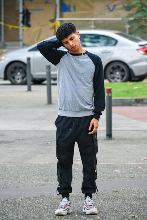 Handsome Young Man in Sneakers Posing on Street