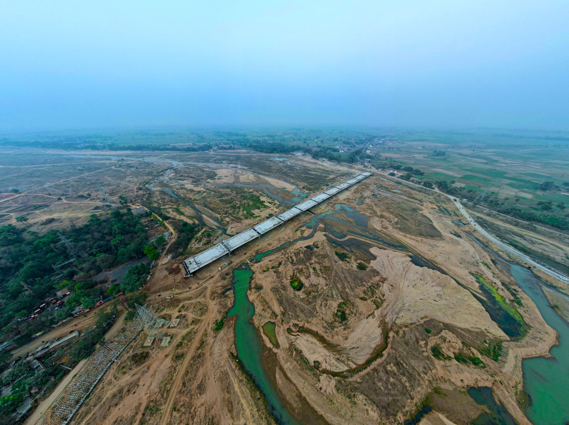 Aerial view of a rural construction site with a barren landscape and development.