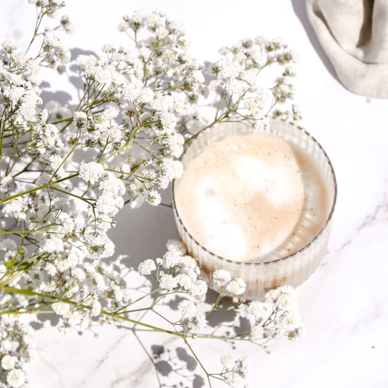 Pale cocktail styled with white blossom — photo by Studio Naae on Pexels