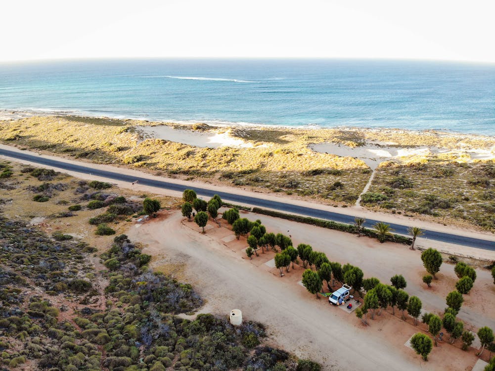 Aerial Shot Of Road Near Body Of Water