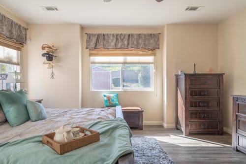 Interior of a Bedroom with a Large Bed and Wooden Furniture 