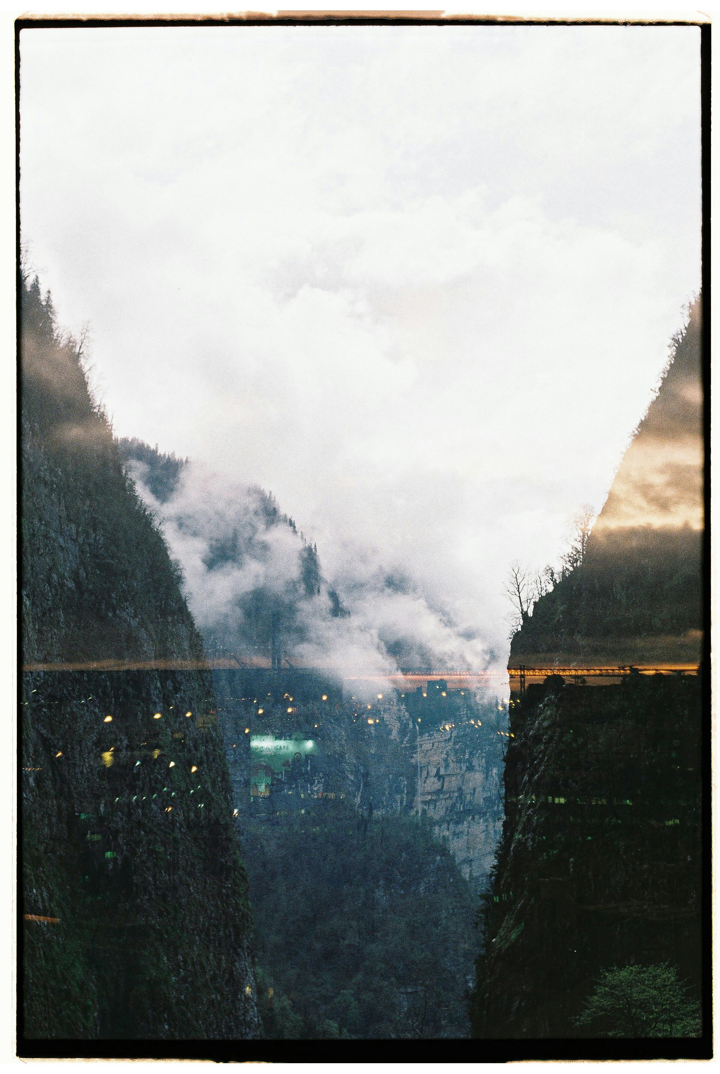 Scenic canyon view with dramatic overcast clouds and reflections in a vertical frame.