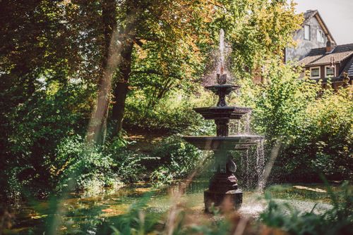 Free Serene fountain in a vibrant park setting in Einbeck, Germany. Stock Photo