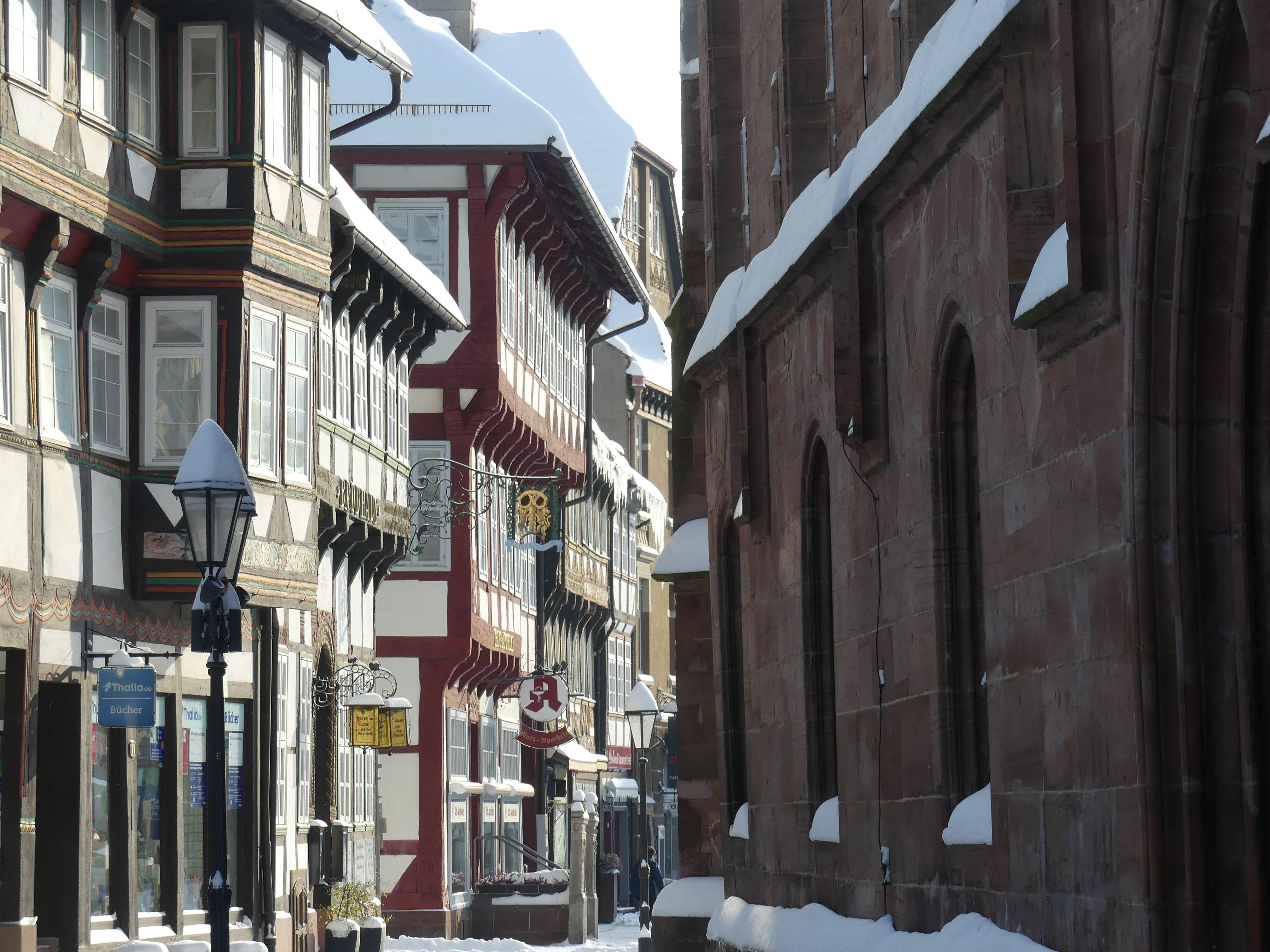 Charming snow-covered street in Einbeck, showcasing traditional German architecture under winter's embrace.
