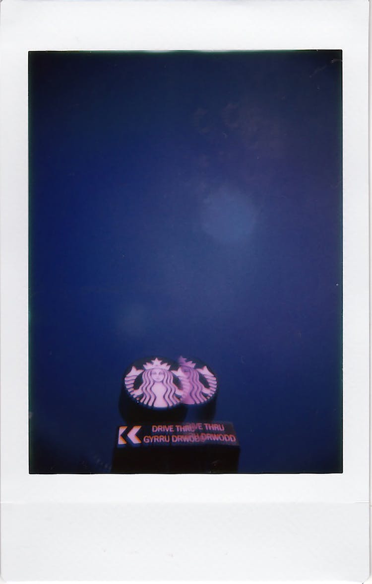 Polaroid Picture Of The Starbucks Sign On A Pole 