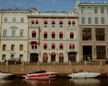 Luxurious riverside view with boats and historic buildings in Saint Petersburg, Russia.