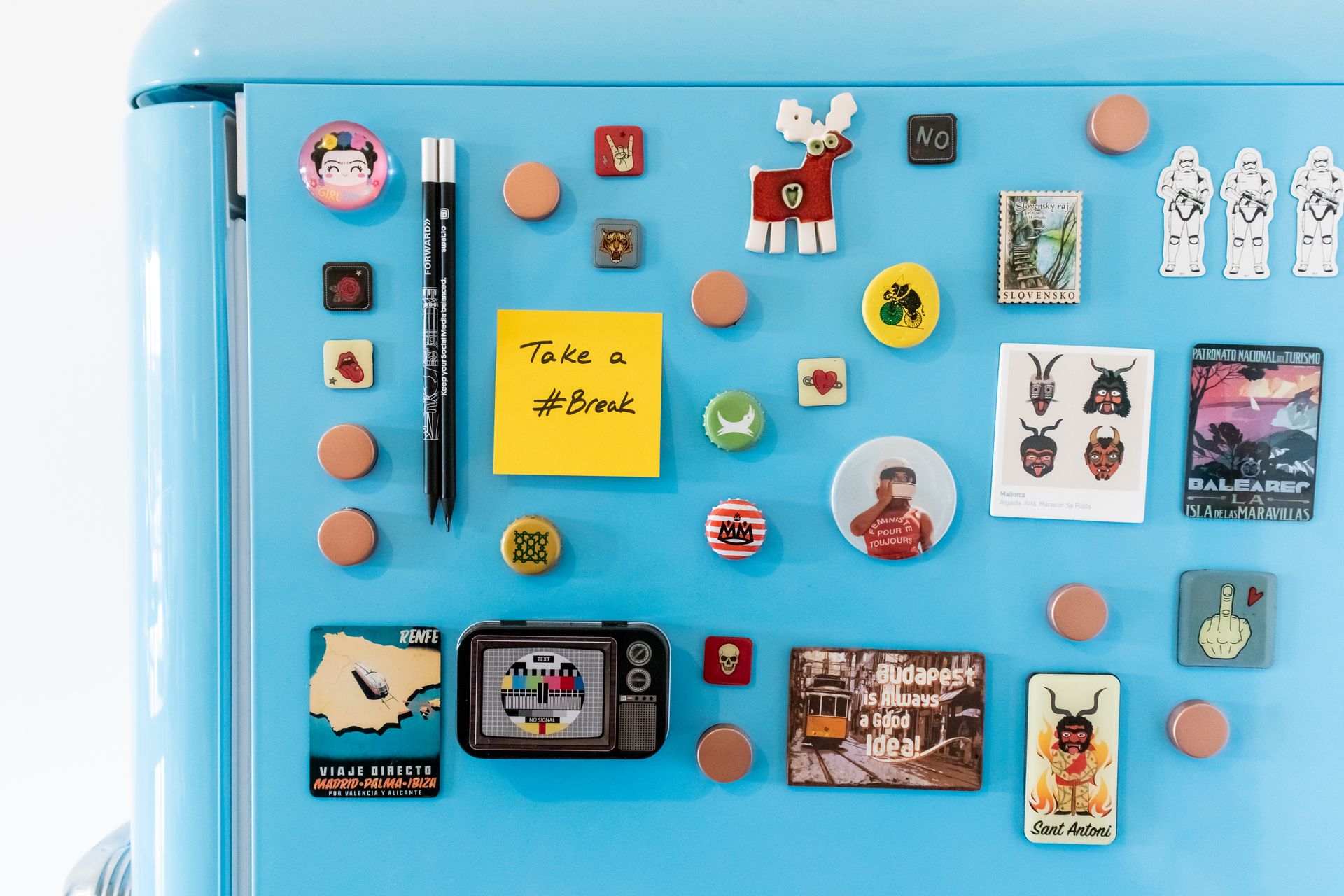 Close-up of a Blue Refrigerator with Colorful Magnets