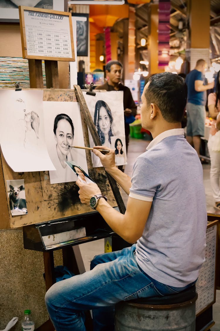 Sitting Man Drawing A Portrait