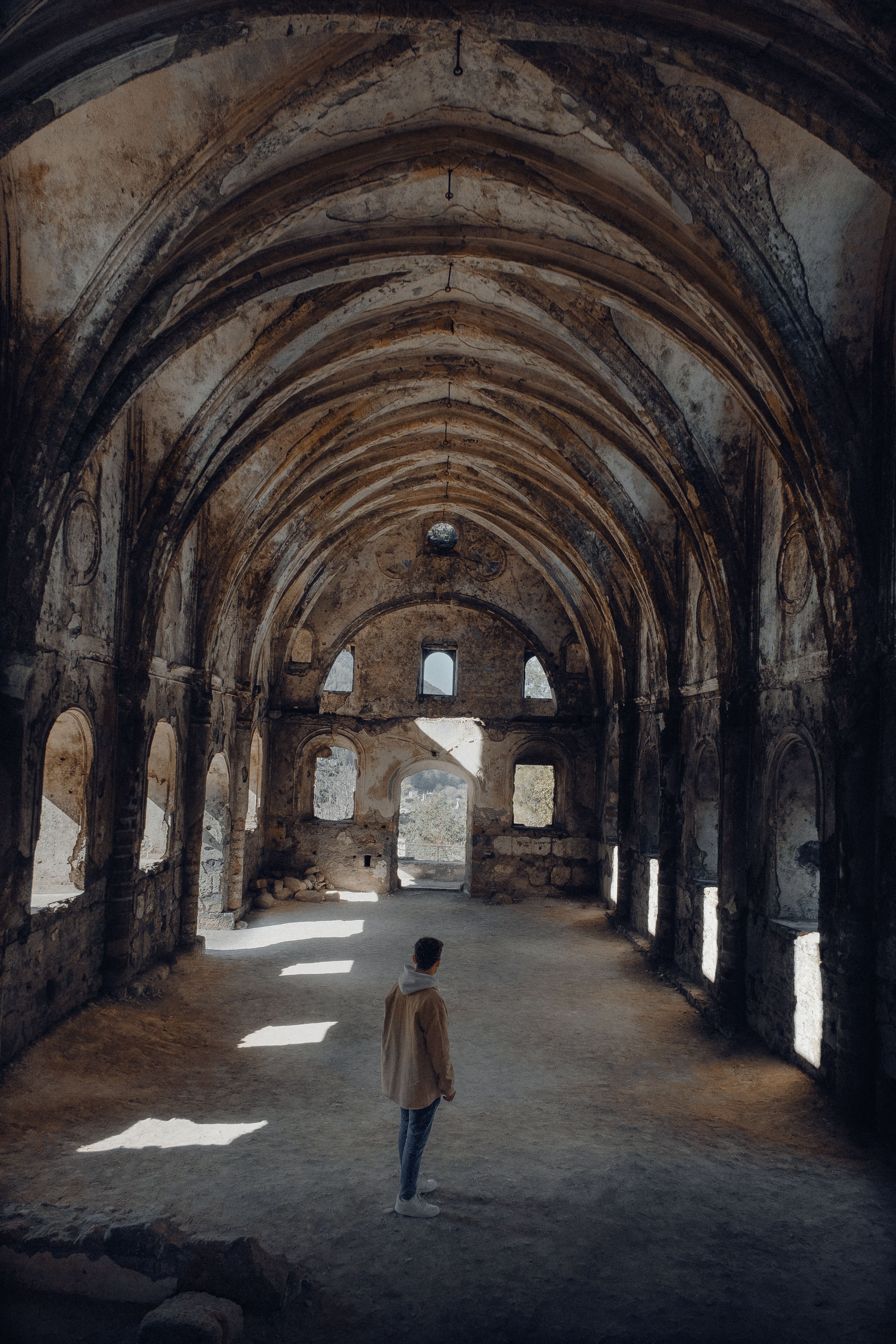 Man Standing in Abandoned Gothic Church · Free Stock Photo