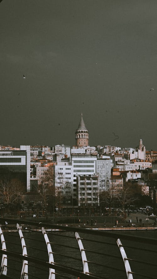 Istanbul Skyline with View of the Galata Tower under a Dark, Cloudy Sky