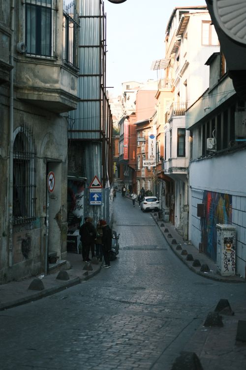 Free Narrow cobblestone street lined with traditional houses in a historic urban setting. Stock Photo