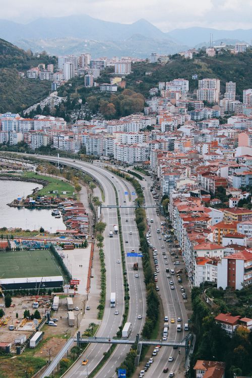 Free Aerial view of Giresun cityscape with a bustling highway and surrounding greenery in Türkiye. Stock Photo