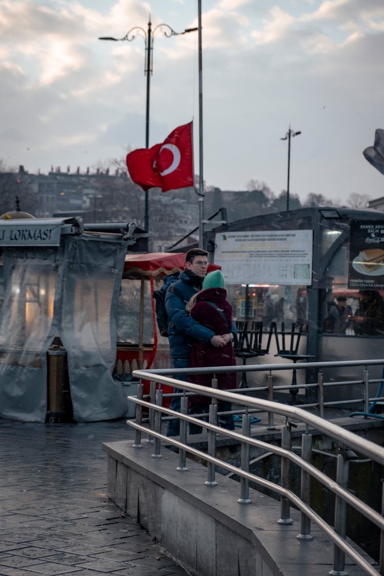 Couple Walking Past Street Vendors Stalls