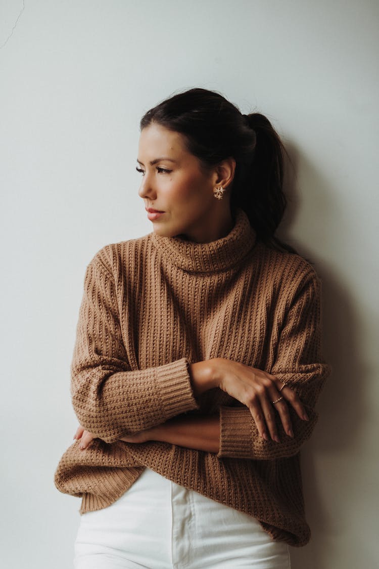 Woman In Beige Turtleneck And White Pants 