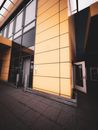 Exterior view of a modern office building in Berlin with a striking yellow facade.