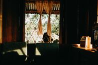 A charming rustic interior with vintage decor and soft natural light through a window.