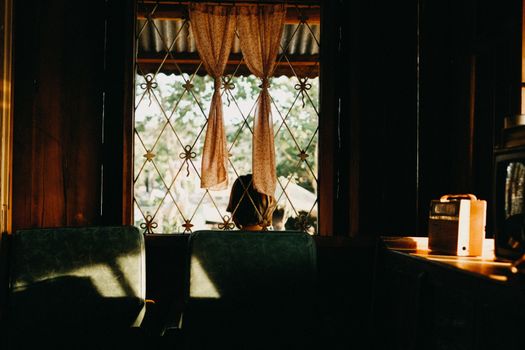 A charming rustic interior with vintage decor and soft natural light through a window.