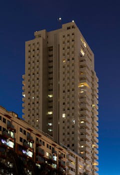 Stunning night view of a modern high-rise building in Valencia, Spain.