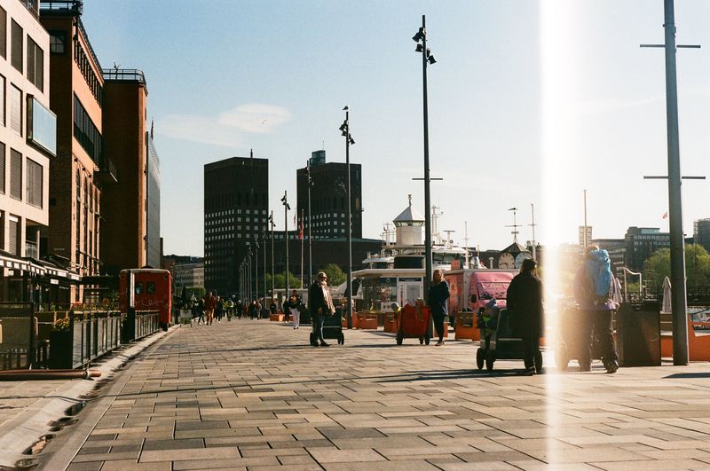 Waterfront promenade at Aker Brygge with Oslo City Hall in the background