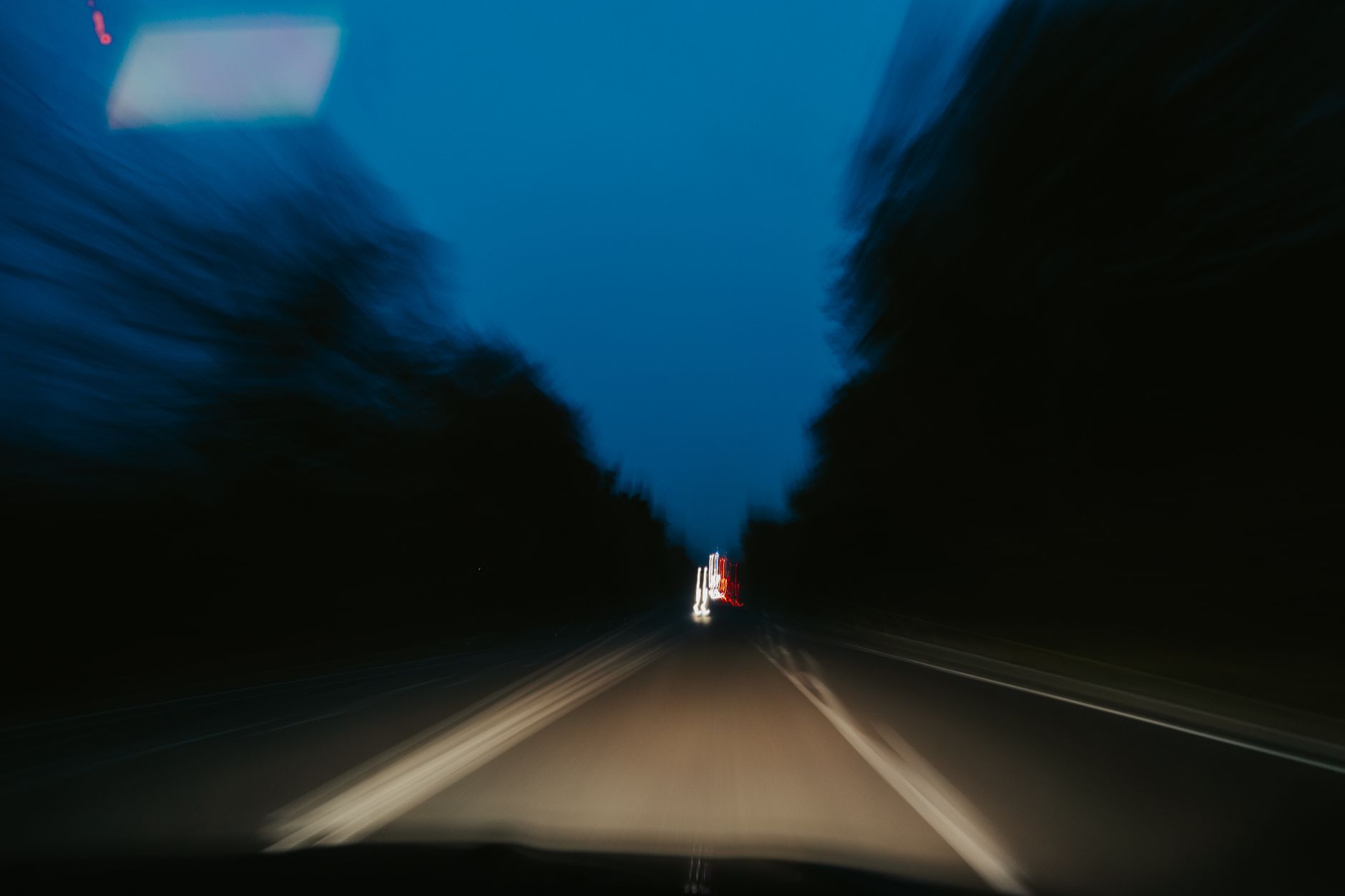 Dynamic nighttime road view showcasing speed and motion blur.