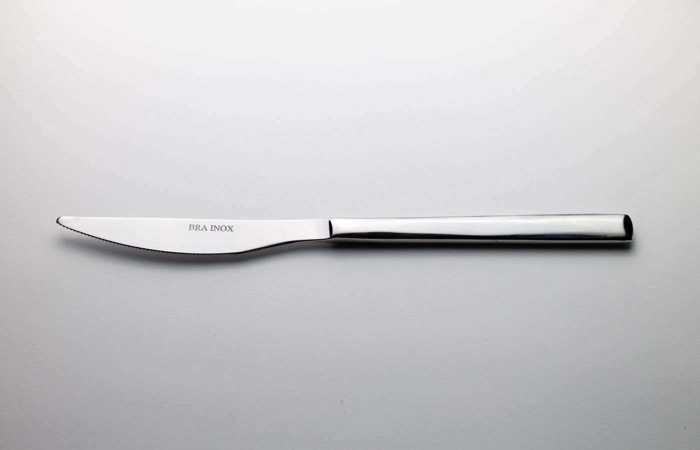 Simple and elegant stainless steel knife on a plain background.