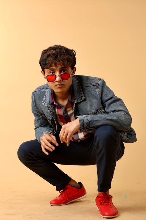 Young Man in Trendy Outfit and Red Sunglasses 