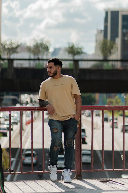 Man in T-shirt Posing over Highway in City