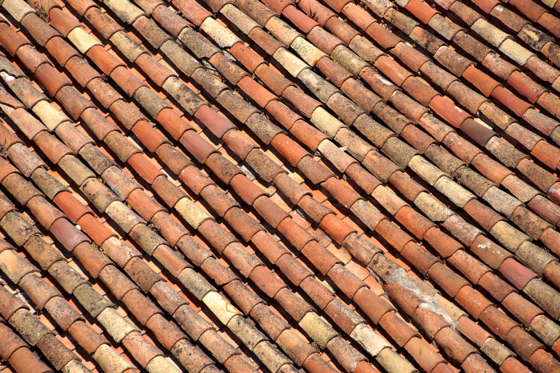 Close-up view of traditional clay roof tiles, showcasing texture and color variation.