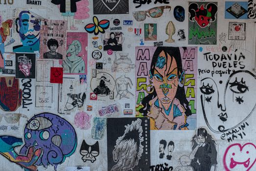 Vibrant urban wall filled with diverse street art and graffiti in Ciudad de México.