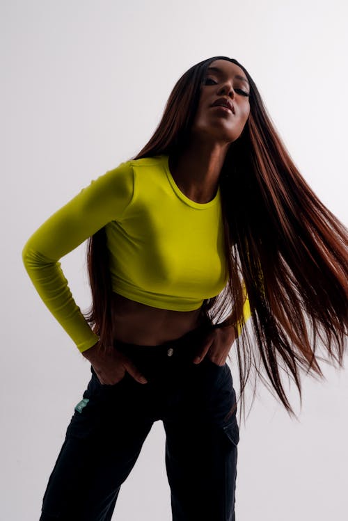 Woman in Yellow Shirt Posing on White Background 