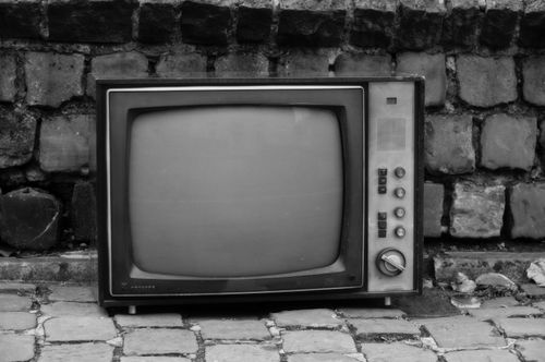 Free Black and white photo of a retro television on a cobblestone street in Mons, Belgium. Stock Photo