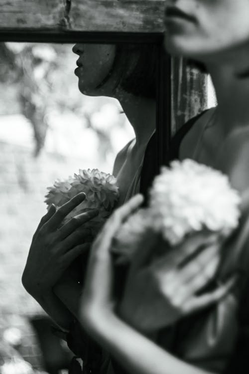 Woman with Flowers and Her Reflection in Mirror