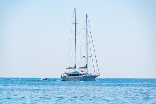 Motor Yacht with Masts and Motorboat behind