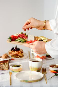 A stylish breakfast table with a variety of gourmet foods and beverages.