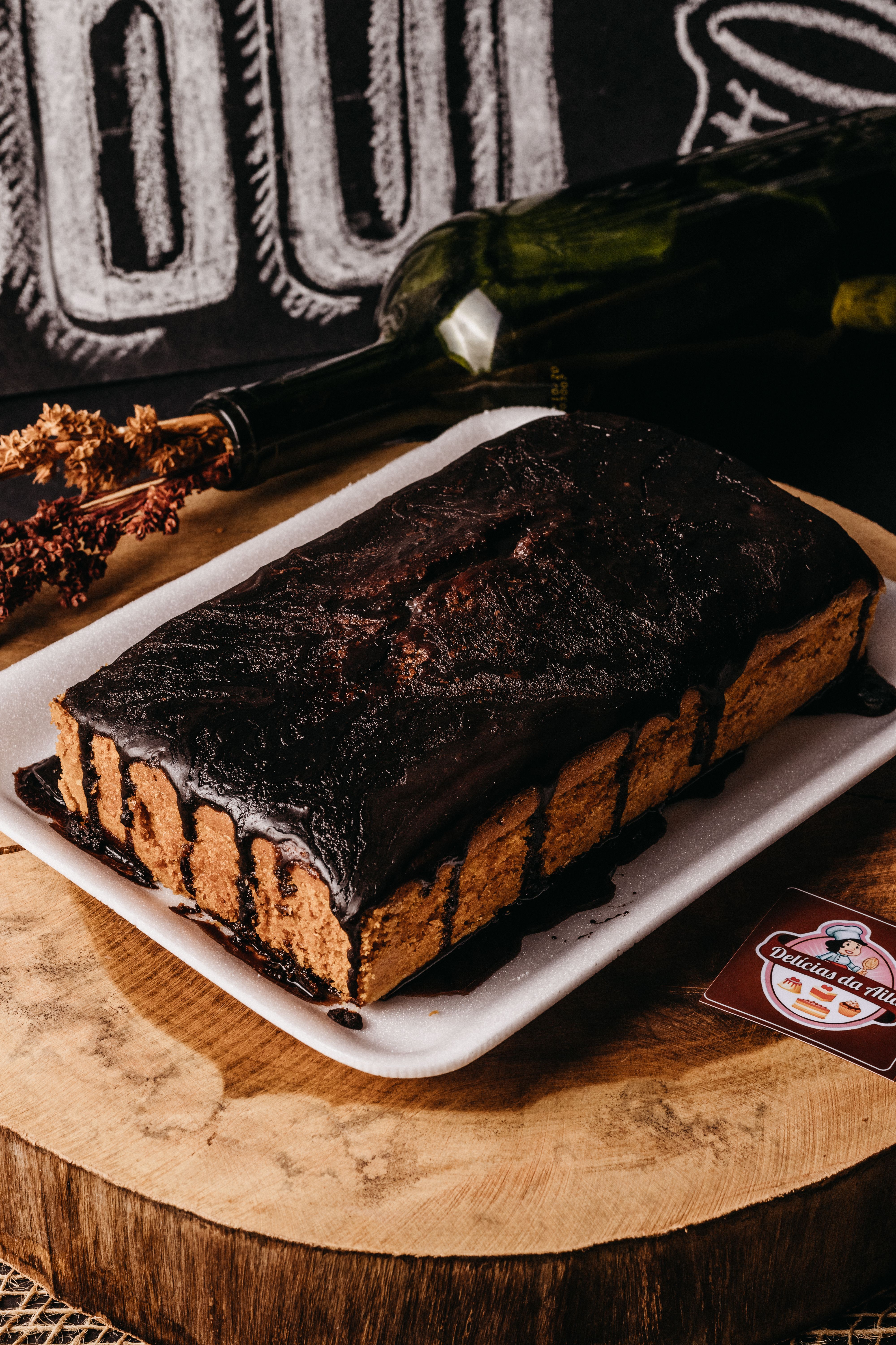 Scrumptious chocolate cake with glaze on wooden board, perfect for dessert lovers.