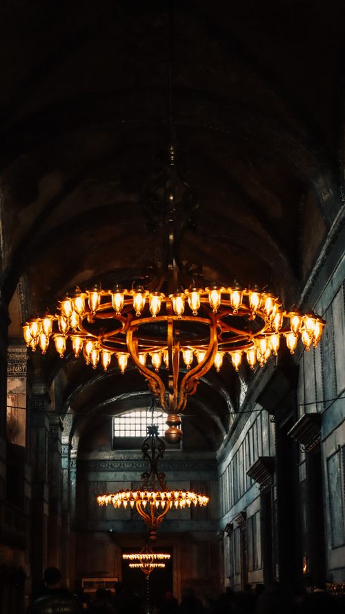 Free A stunning view of illuminated chandeliers in a classic historical temple setting. Stock Photo