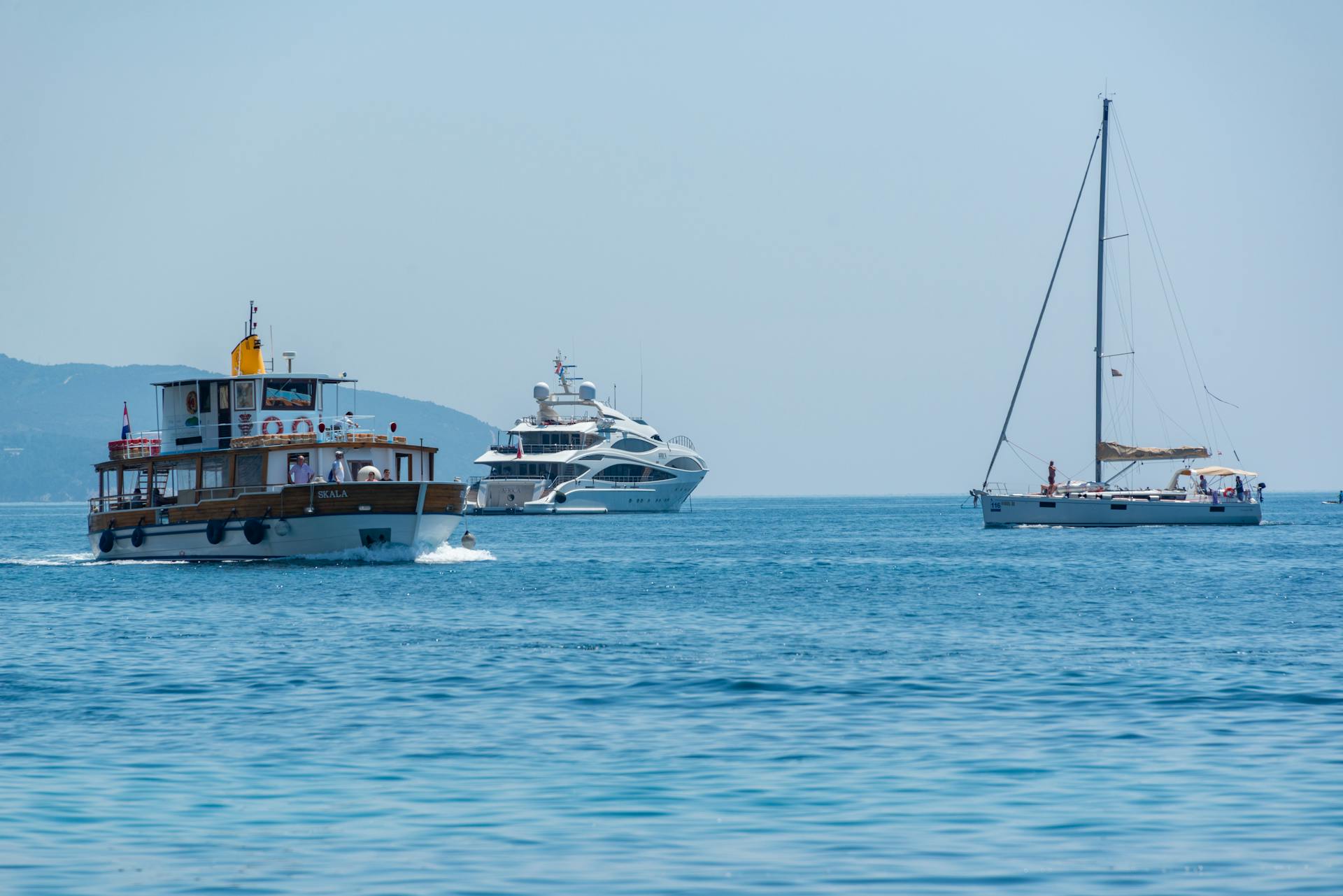 Boats cruising on a clear blue sea under a bright sky, perfect for maritime adventures.