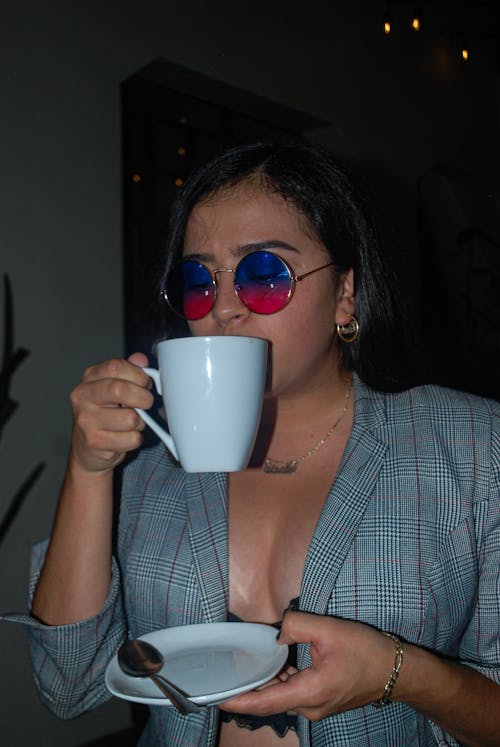 Brunette Woman Drinking Coffee in Evening
