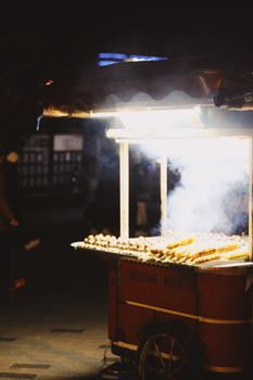 Street food stall with roasted corn at night in Istanbul, Turkey.
