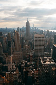 Breathtaking view of New York City skyline featuring the iconic Empire State Building at sunset.