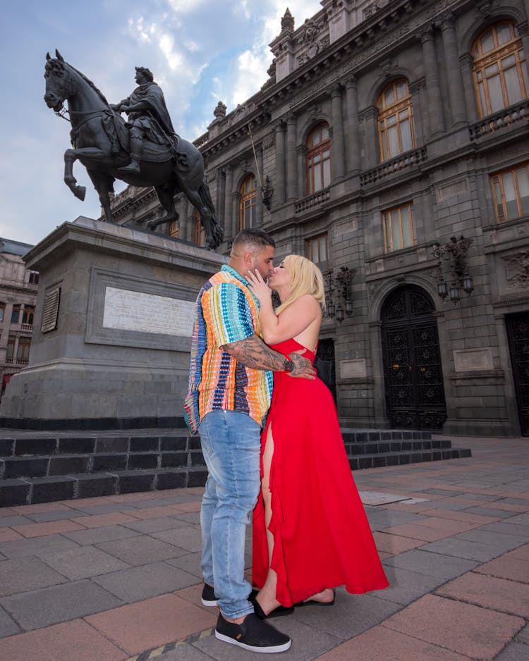 A Couple Standing In Front Of The Art Museum And Equestrian Statue And Kissing, Mexico City, Mexico