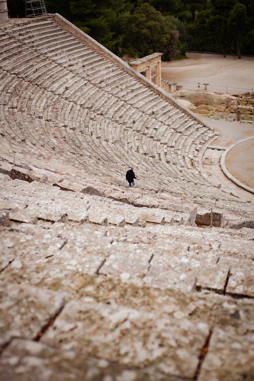 Man Walking Down Amphitheater Steps