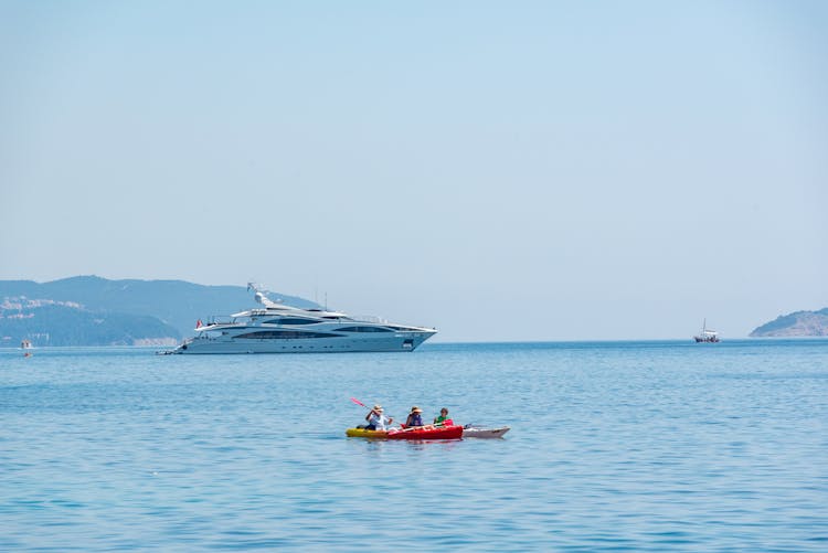 Cruise Boat And A Kayak On The Sea