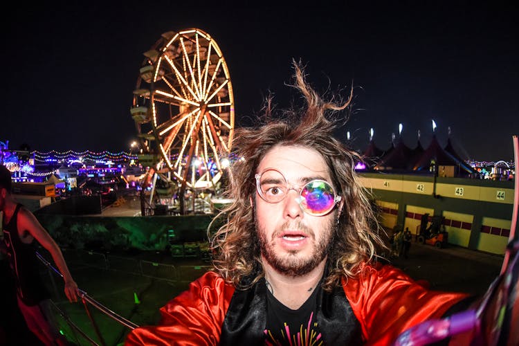 Man In Costume At Night Festival In Amusement Park