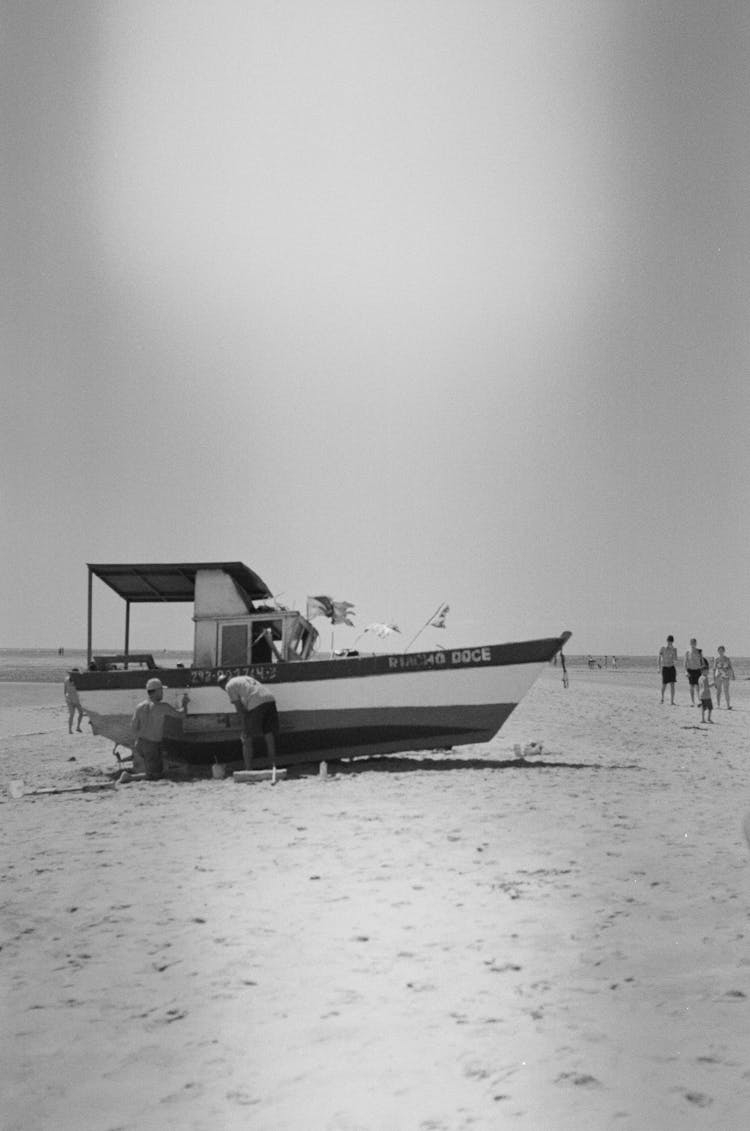 People And Boat On Beach